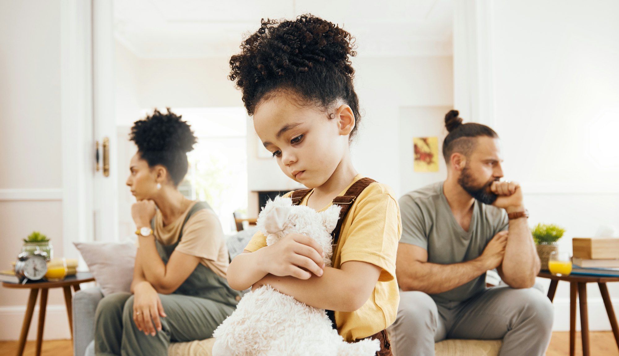 Divorce, custody and sad boy child with teddy bear in living room for stress, support and comfort a